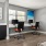 a room with a desk and chairs