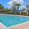a pool with chairs and umbrellas by it