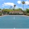 a tennis court with trees and a building in the background