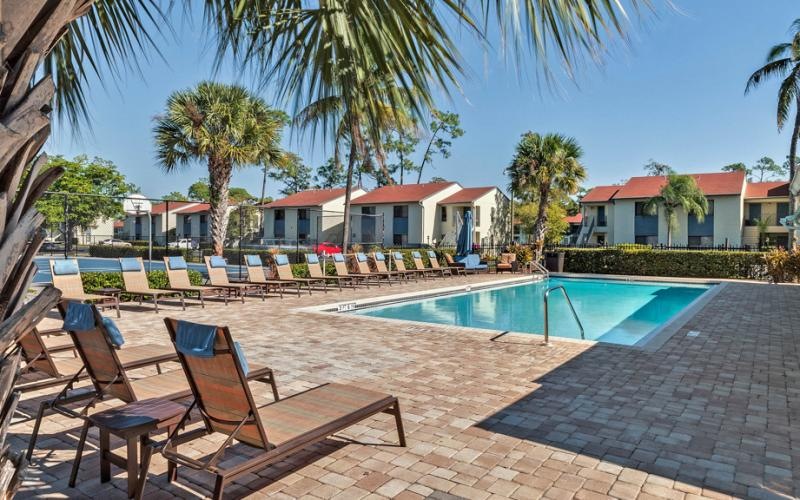 a pool with chairs around it