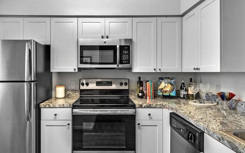 a kitchen with white cabinets