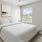 a bedroom with a bed and a fan